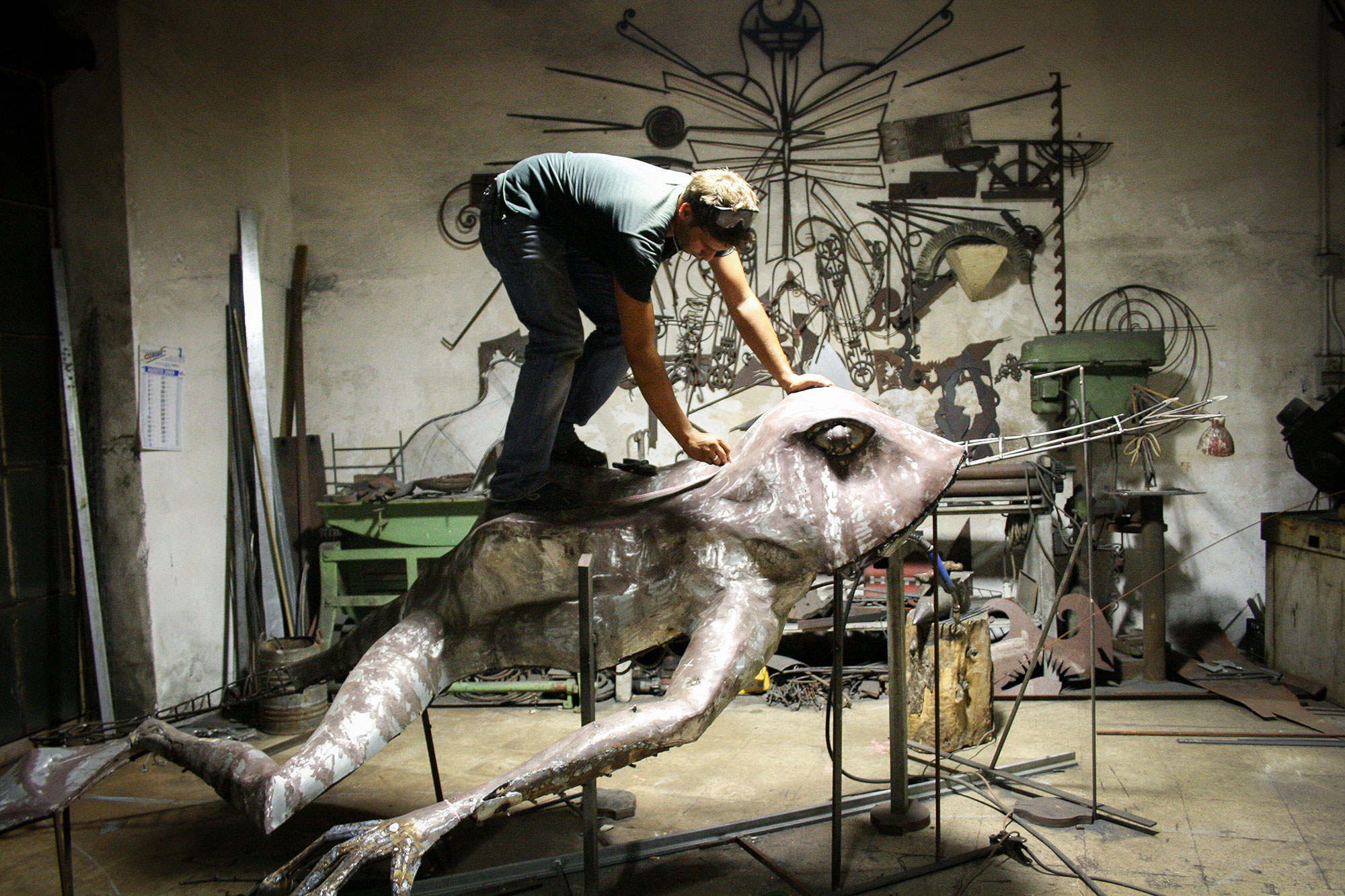 Artist Isaia Zilli working on a Frog statue